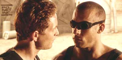 Pitch Black: Johns reminds Riddick that he's on a short leash.