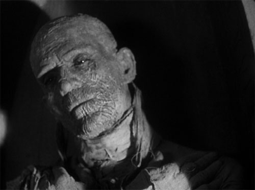The Mummy (1932): Archaeologist Ralph Norton unwisely begins to translate the Scroll of Thoth. Behind him, we see the glimmer of eye-shine in Im-ho-tep.